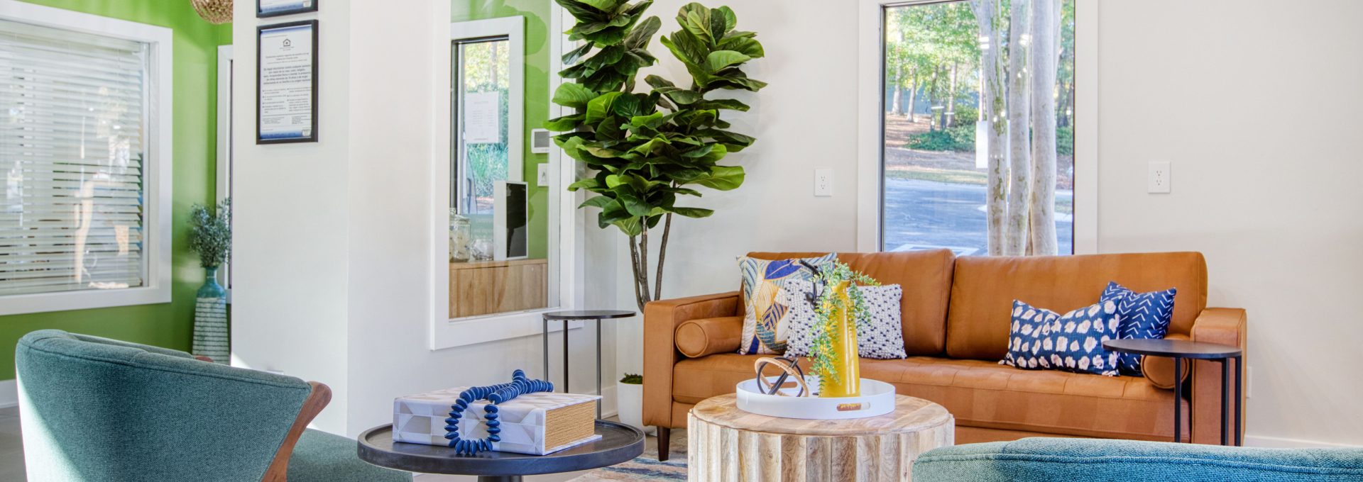 a living room with green walls and blue furniture at The Terra at Norcross