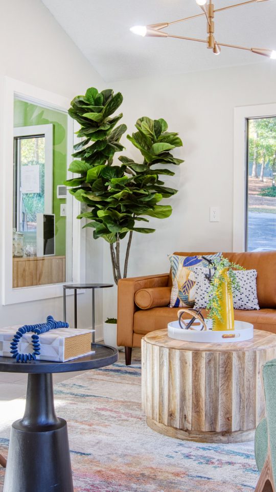 a living room with green walls and blue furniture at The Terra at Norcross