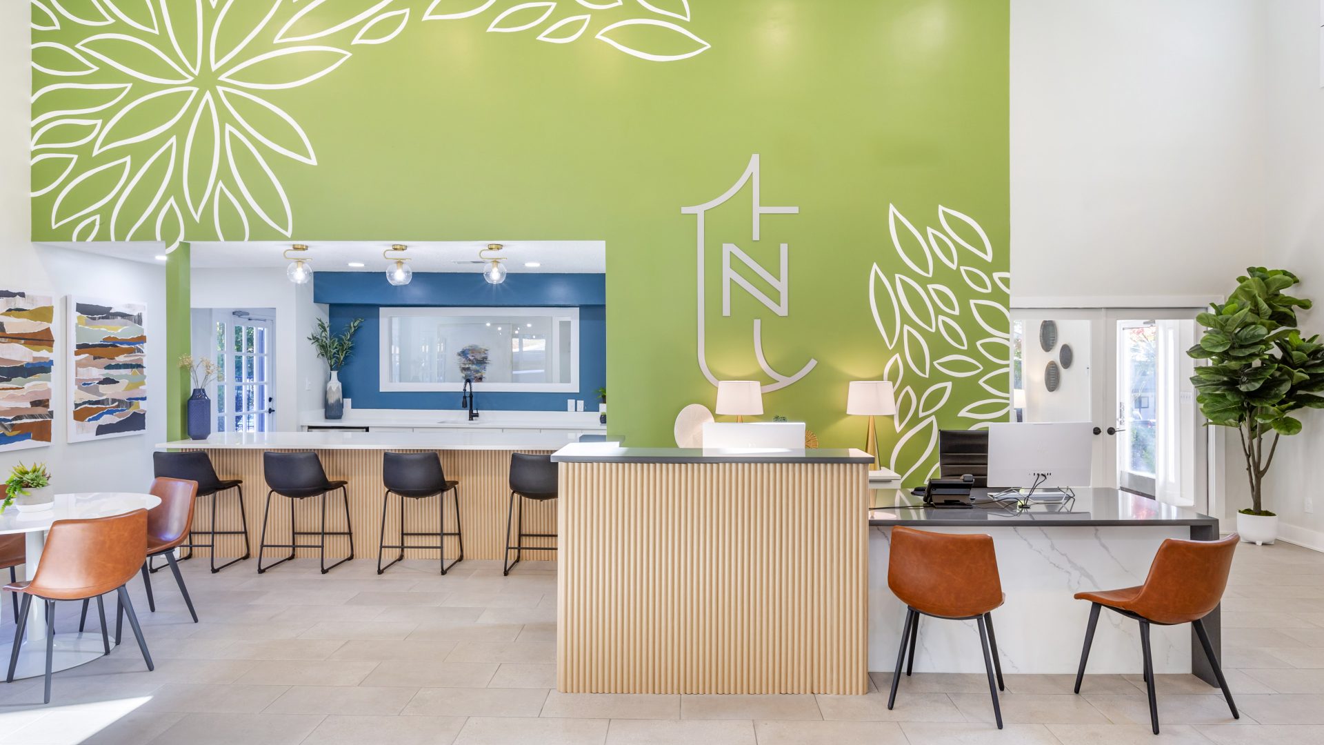 a modern office with green walls and a reception desk at The Terra at Norcross